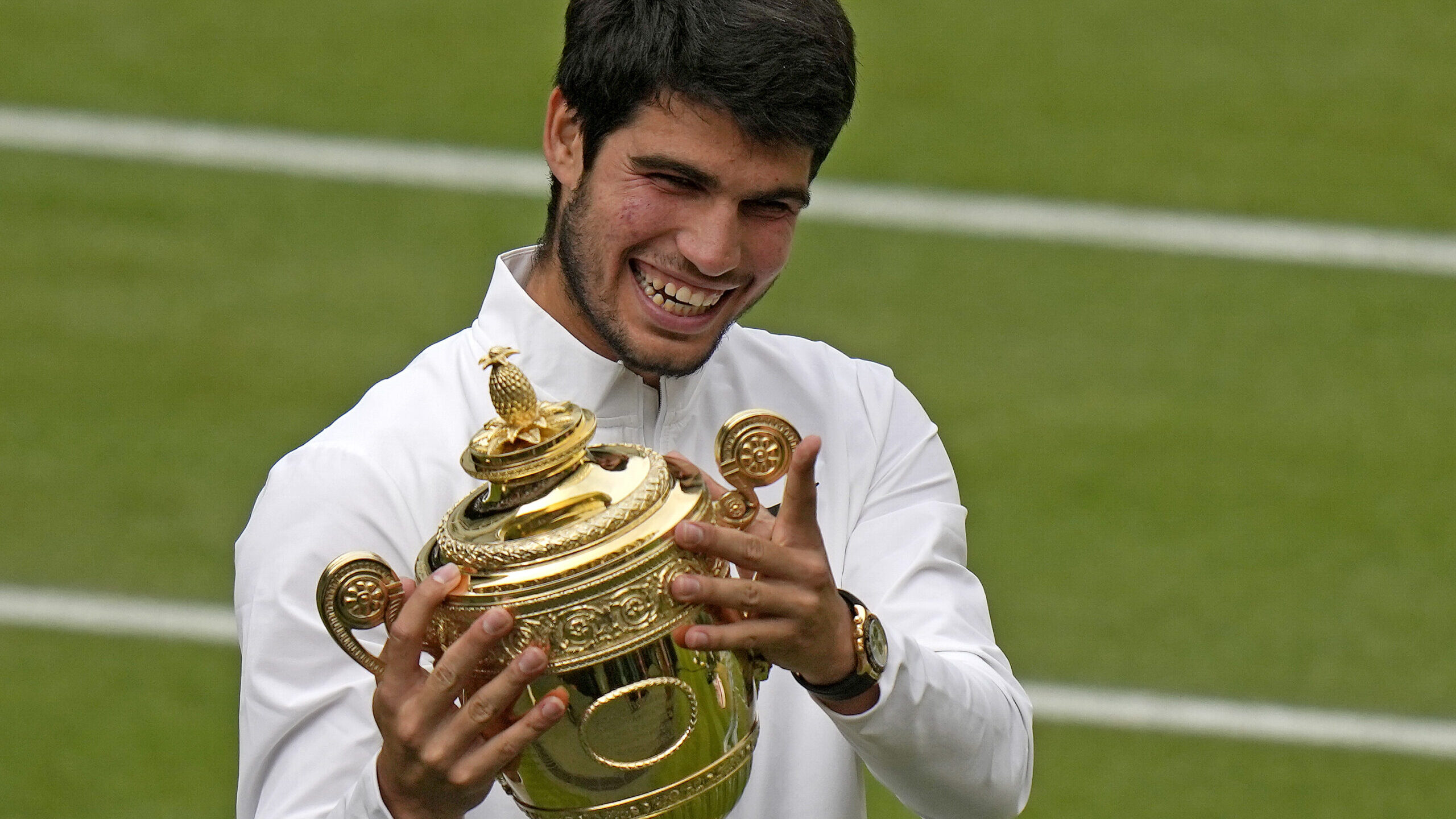 Spain's Carlos Alcaraz celebrates with the trophy after beating Serbia's Novak Djokovic to win the ...