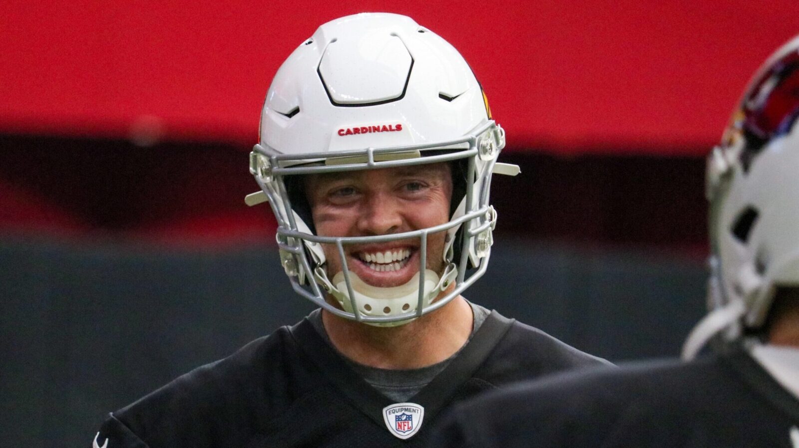 Colt McCoy smiles at training camp...