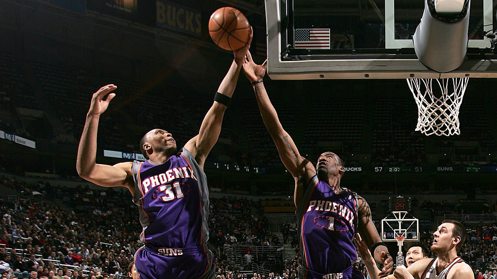 Shawn Marion #31 and Amare Stoudemire #1 of the Phoenix Suns reach for a rebound against Andre Bogu...