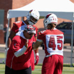 Arizona Cardinals outside linebackers coach Robert Rodriguez works with Zaven Collins and Dennis Gardeck during minicamp on Tuesday, June 13, 2023, in Tempe. (Tyler Drake/Arizona Sports)